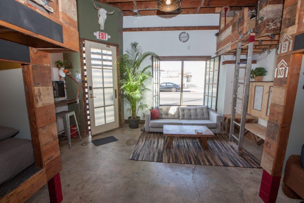 Bunk beds flank a living area with a sofa.