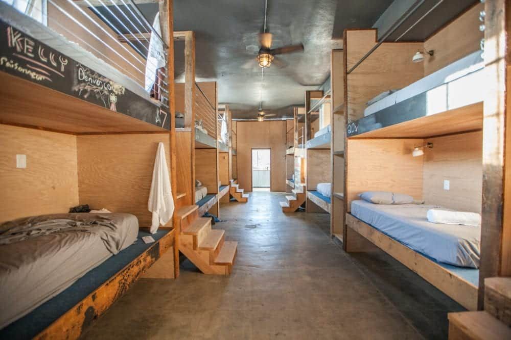 Dorm room with wooden bunk beds.
